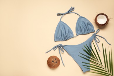 Flat lay composition with beautiful swimsuit on beige background. Space for text
