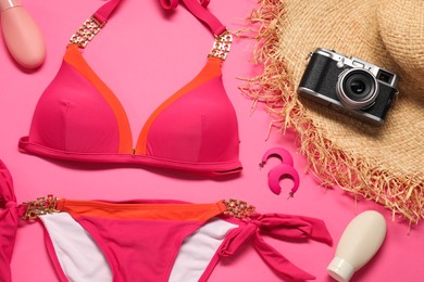 Photo of Flat lay composition with beautiful swimsuit on pink background