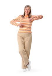 Happy senior woman pointing on white background