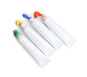 Photo of Many tubes with colorful paints isolated on white, top view