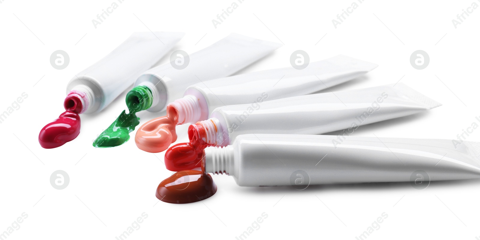 Photo of Many tubes with colorful paints isolated on white