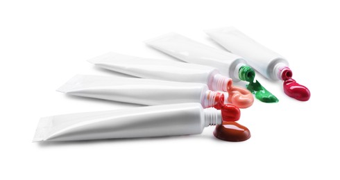 Photo of Many tubes with colorful paints isolated on white