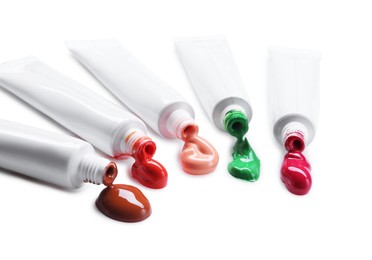 Photo of Many tubes with colorful paints isolated on white