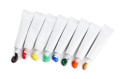 Photo of Tubes with colorful paints isolated on white, top view