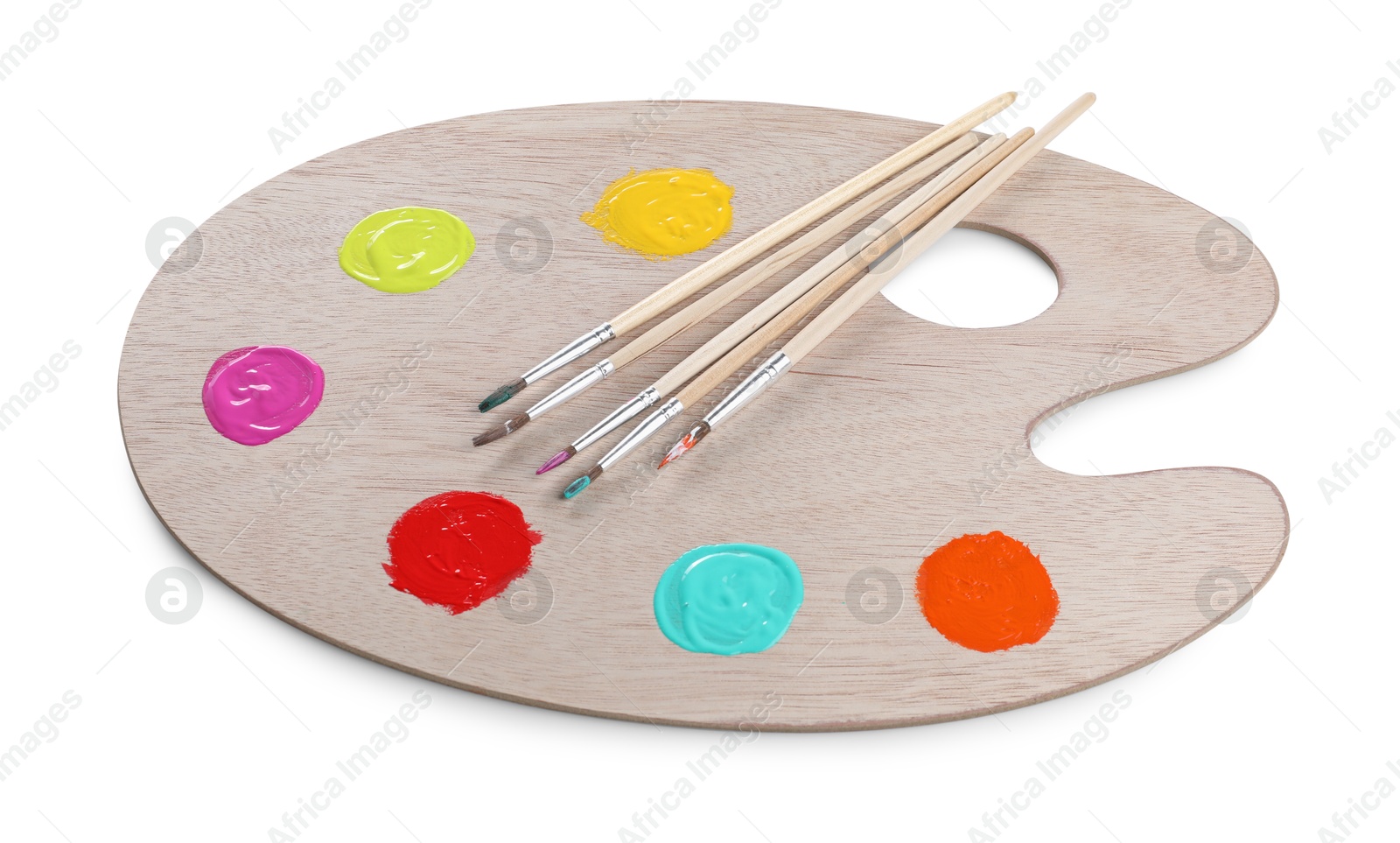 Photo of Wooden artist's palette with samples of paints and brushes isolated on white