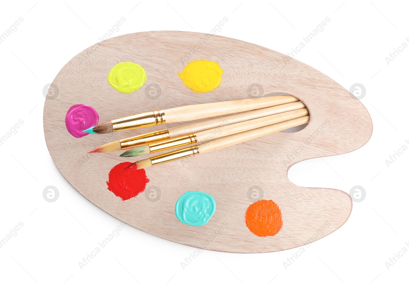 Photo of Wooden artist's palette with samples of paints and brushes isolated on white