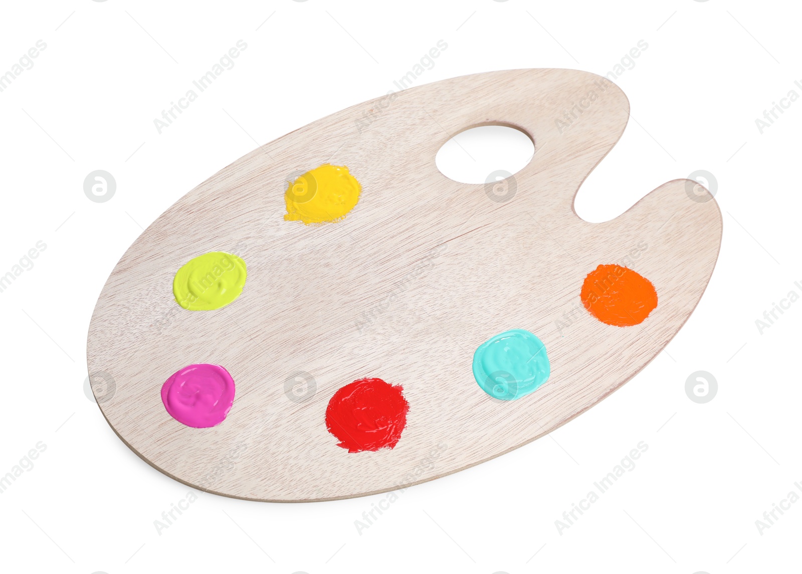 Photo of Wooden artist's palette with samples of paints isolated on white