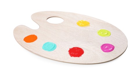 Photo of Wooden artist's palette with samples of paints isolated on white