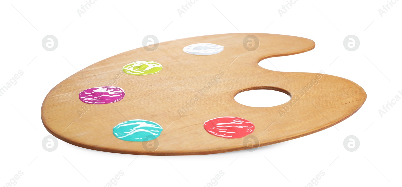 Photo of Wooden artist's palette with samples of paints isolated on white