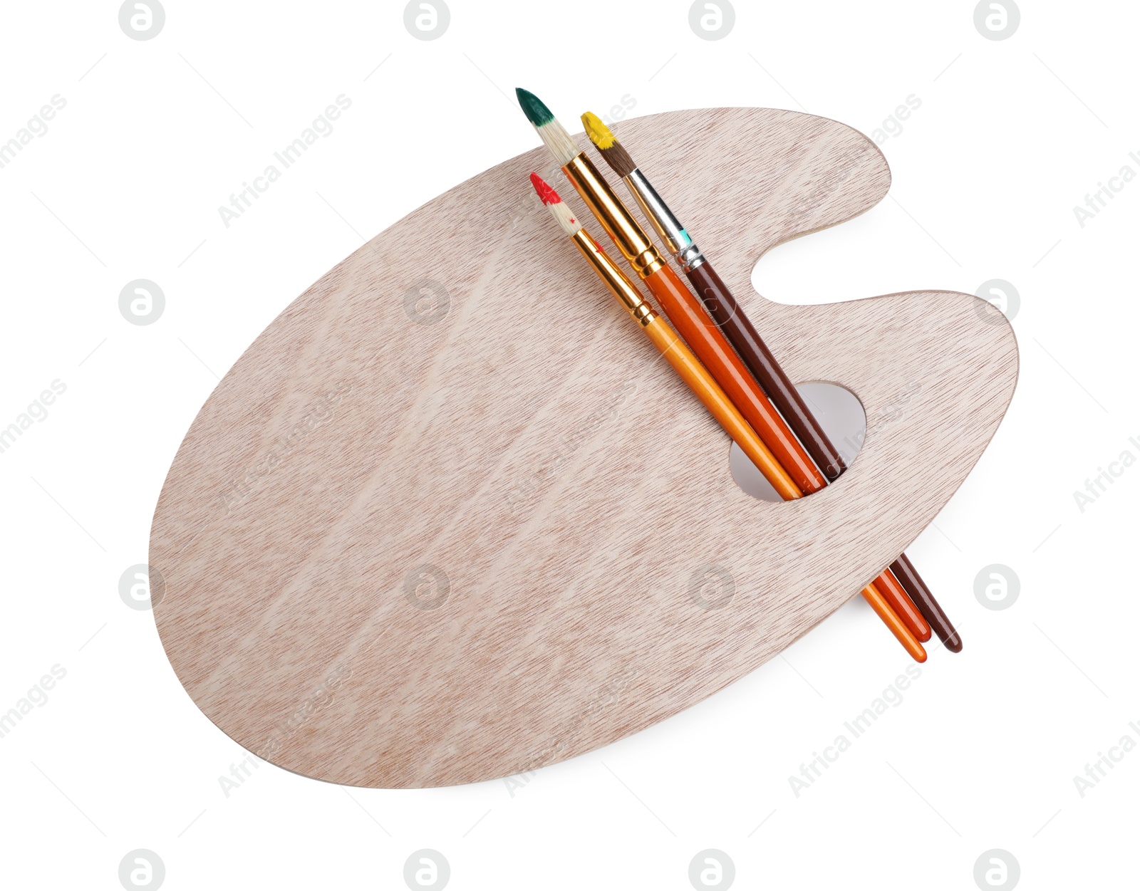 Photo of Brushes with paints and wooden palette isolated on white, top view