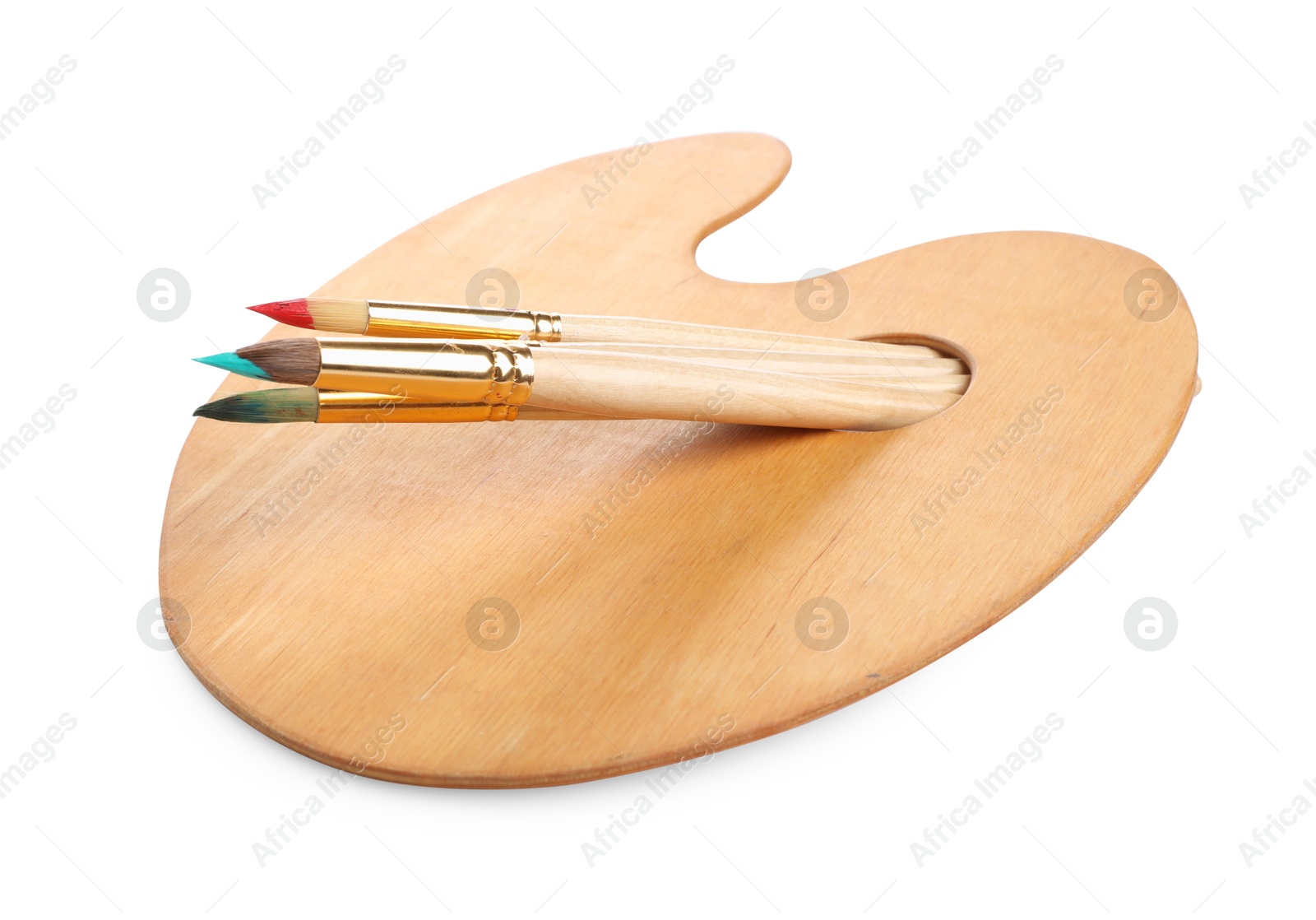 Photo of Brushes with paints and wooden palette isolated on white