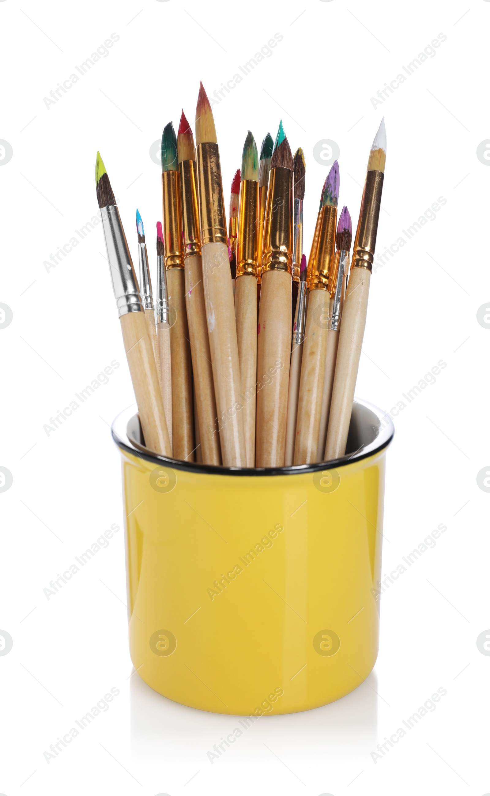 Photo of Wooden brushes with colorful paints in holder isolated on white