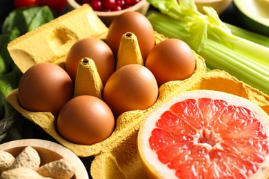 Photo of Grapefruit, eggs, nuts and other healthy food, closeup