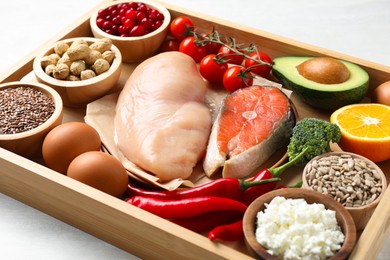 Photo of Tray with many different healthy food on white table, closeup