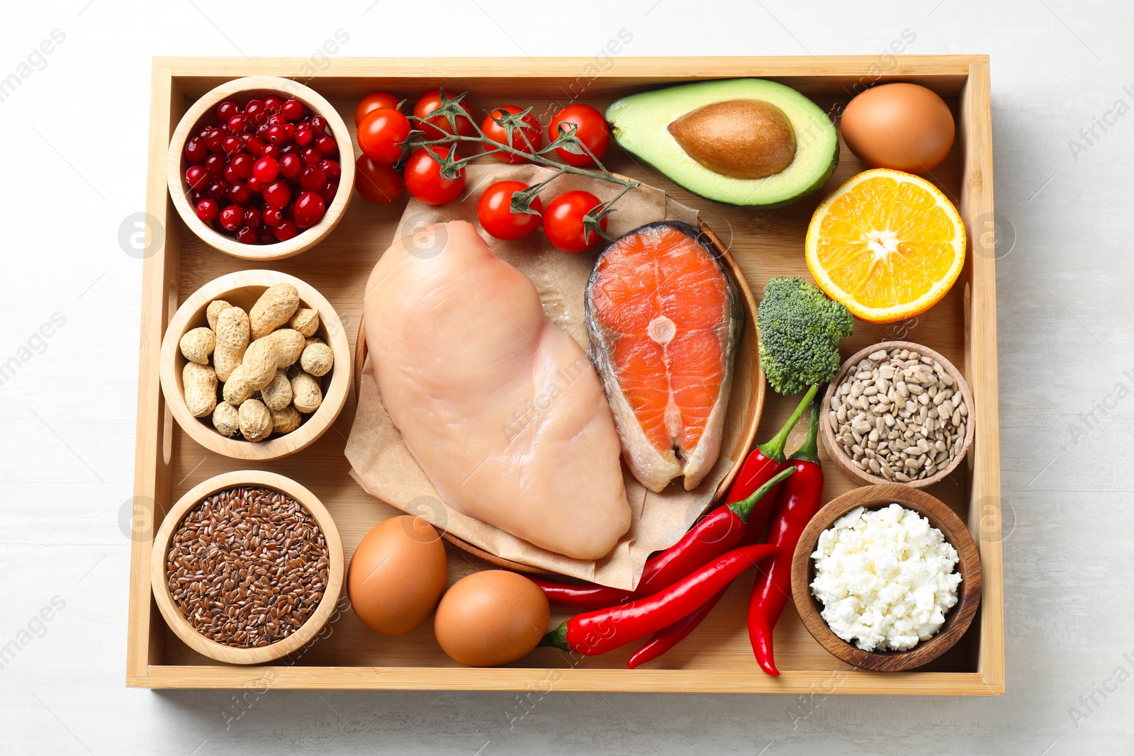 Photo of Tray with many different healthy food on white table, top view