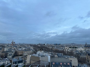 Photo of Beautiful buildings in Paris on cloudy day, view from hotel window