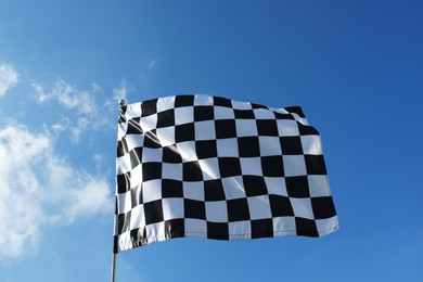 Photo of Checkered flag against blue sky outdoors, low angle view