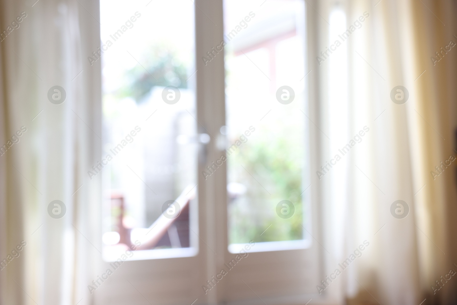 Photo of Blurred view of glass door at home