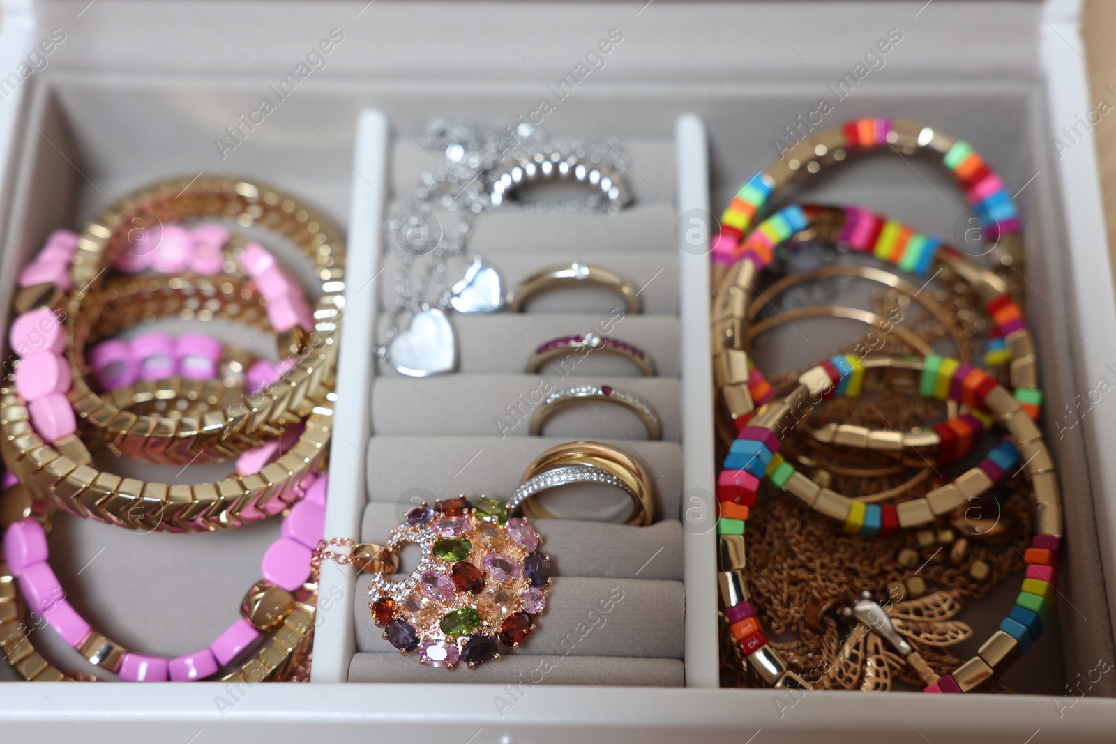 Photo of Jewelry box with beautiful bracelets and other accessories, closeup