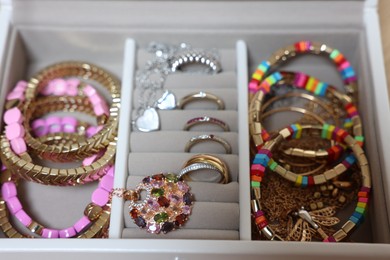 Photo of Jewelry box with beautiful bracelets and other accessories, closeup