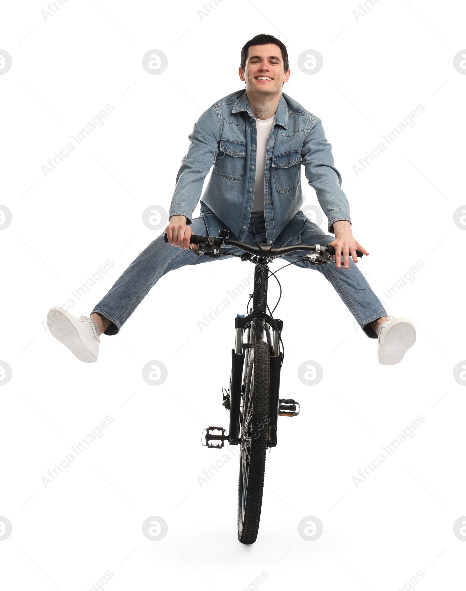 Photo of Smiling man having fun while riding bicycle on white background