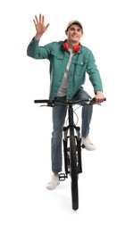 Smiling man with headphones riding bicycle on white background