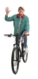 Photo of Smiling man with headphones riding bicycle on white background