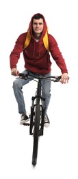 Smiling man with backpack riding bicycle on white background