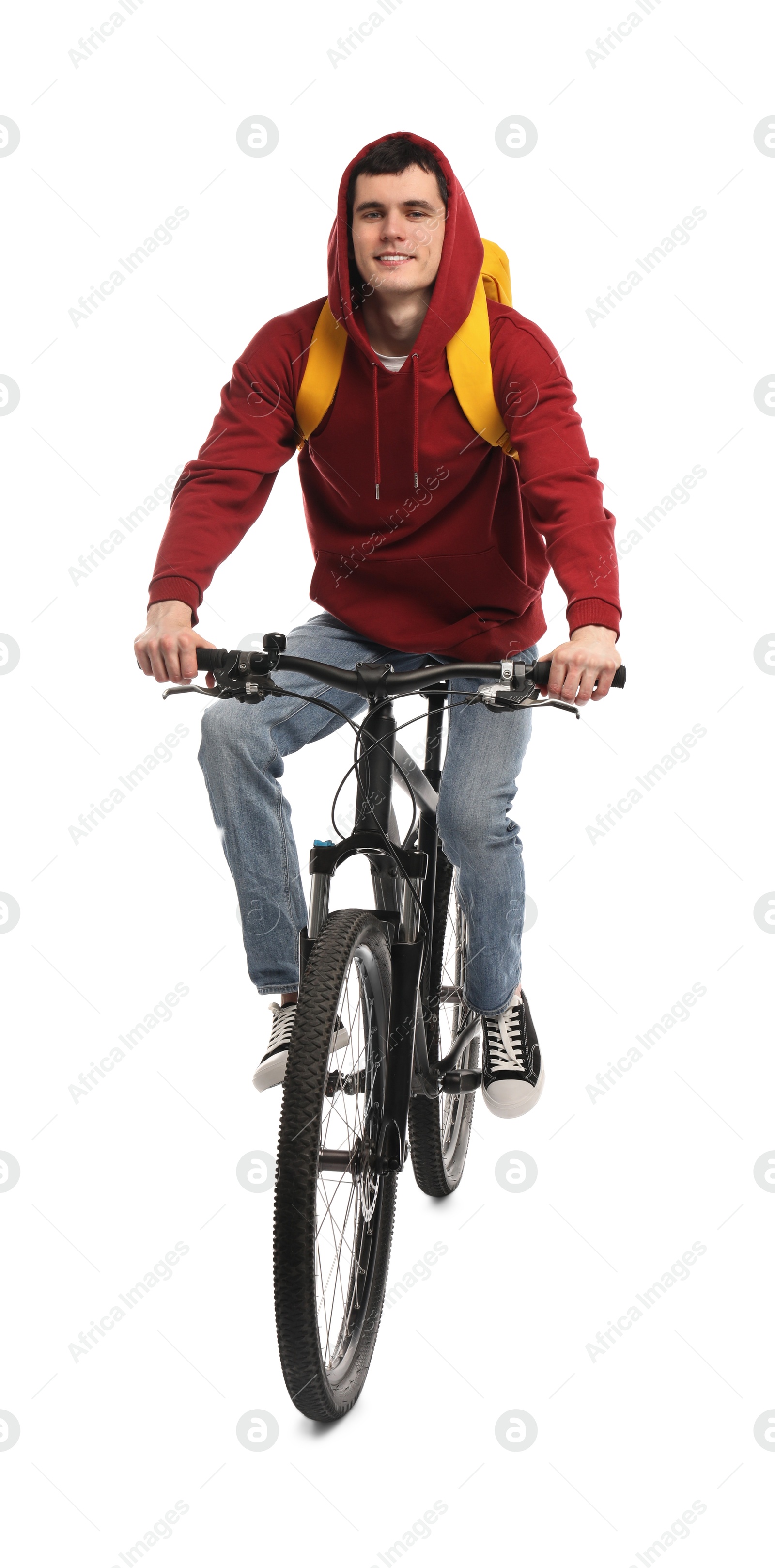 Photo of Smiling man with backpack riding bicycle on white background