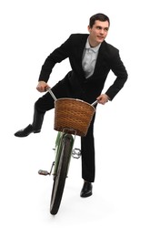 Smiling man on bicycle with basket against white background