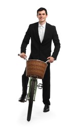 Smiling man on bicycle with basket against white background