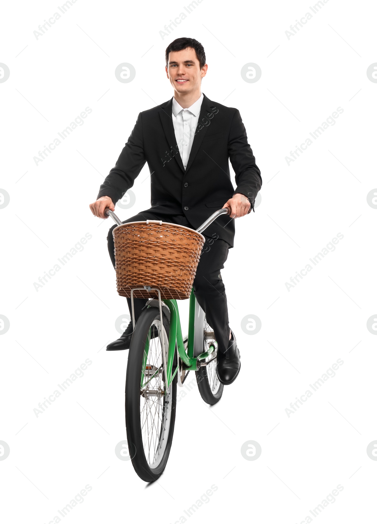 Photo of Smiling man riding bicycle with basket on white background