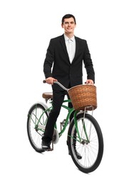 Smiling man on bicycle with basket against white background