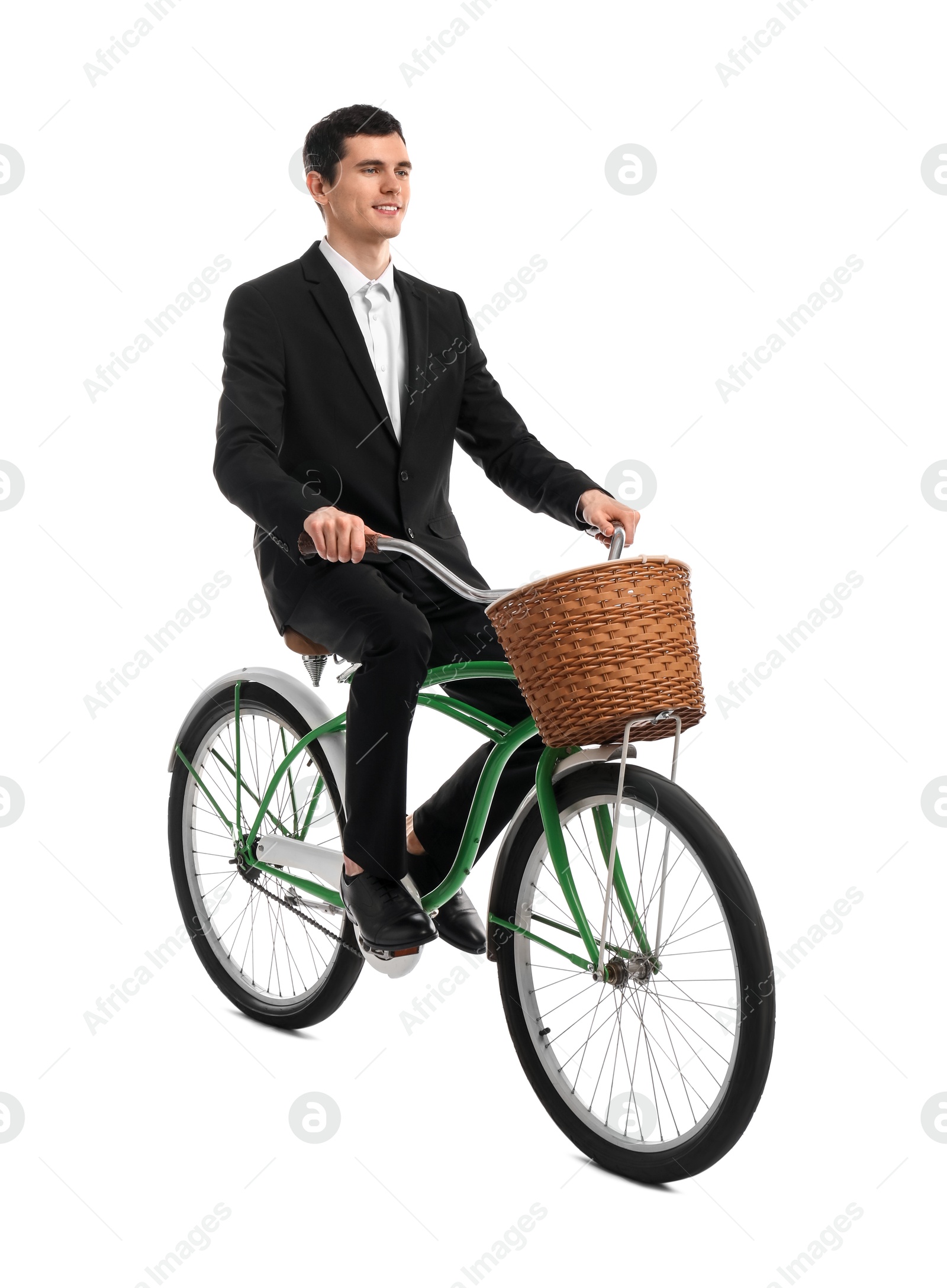 Photo of Smiling man riding bicycle with basket on white background