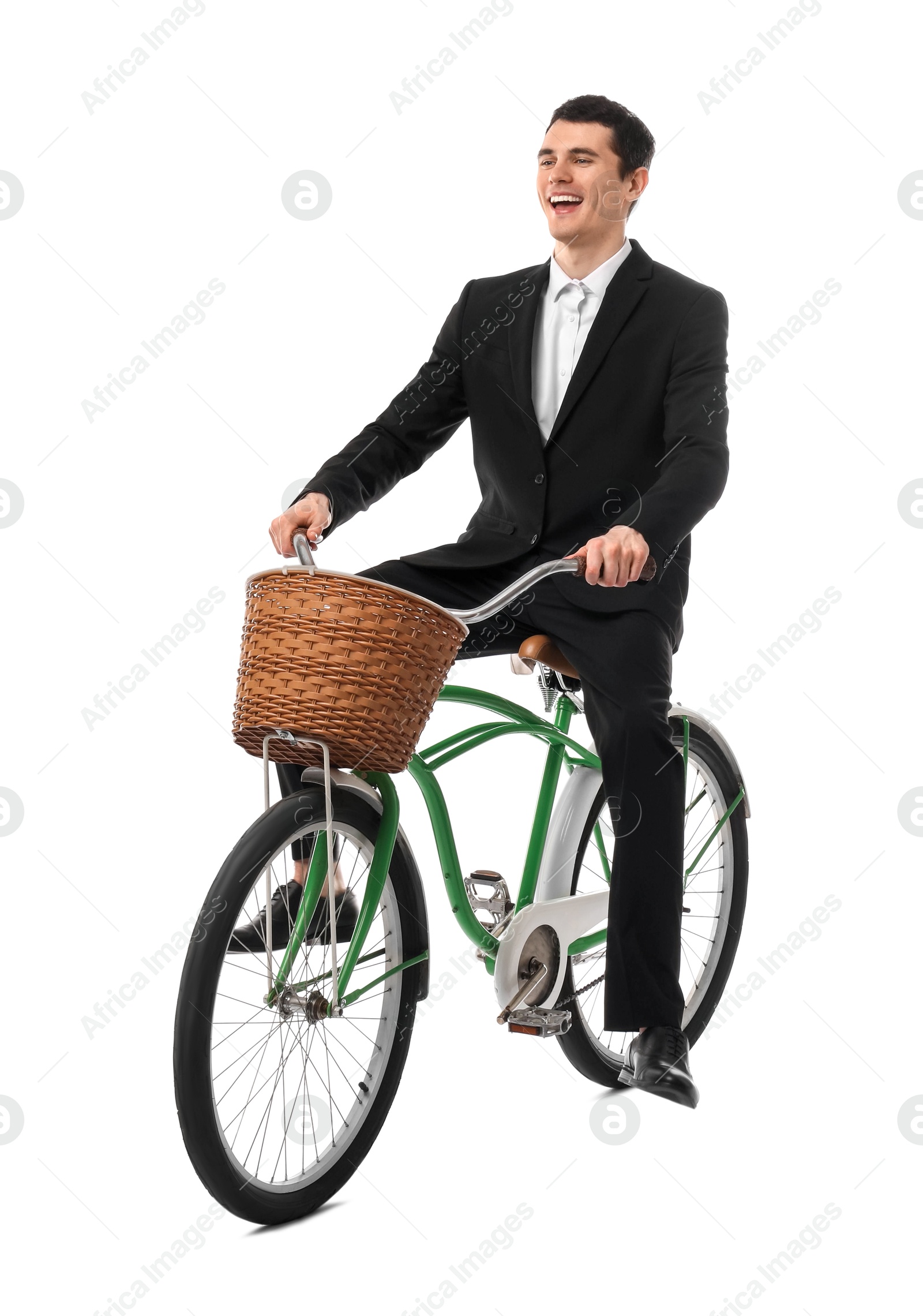 Photo of Smiling man riding bicycle with basket on white background