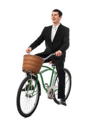 Photo of Smiling man riding bicycle with basket on white background