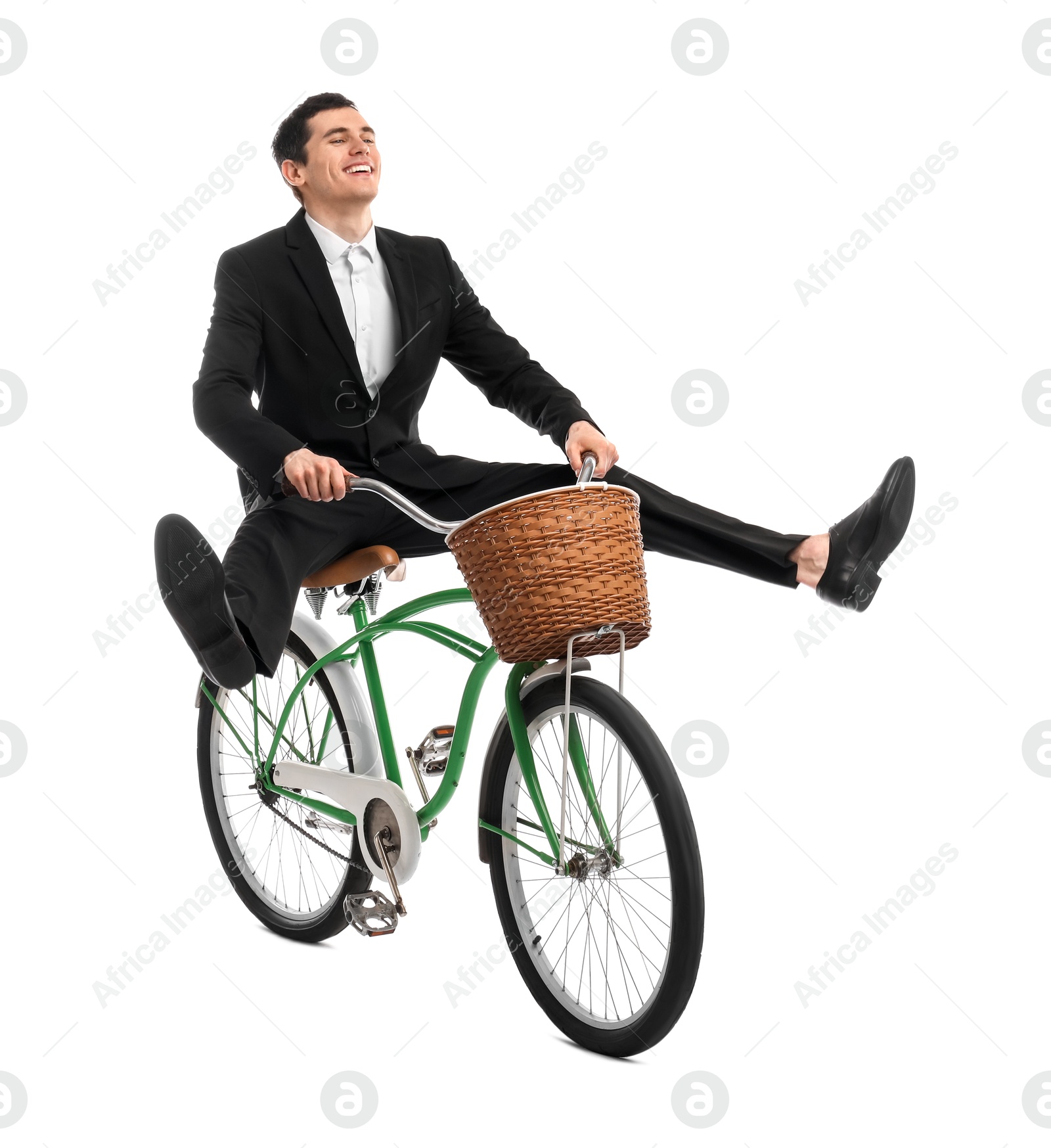 Photo of Smiling man having fun while riding bicycle with basket on white background