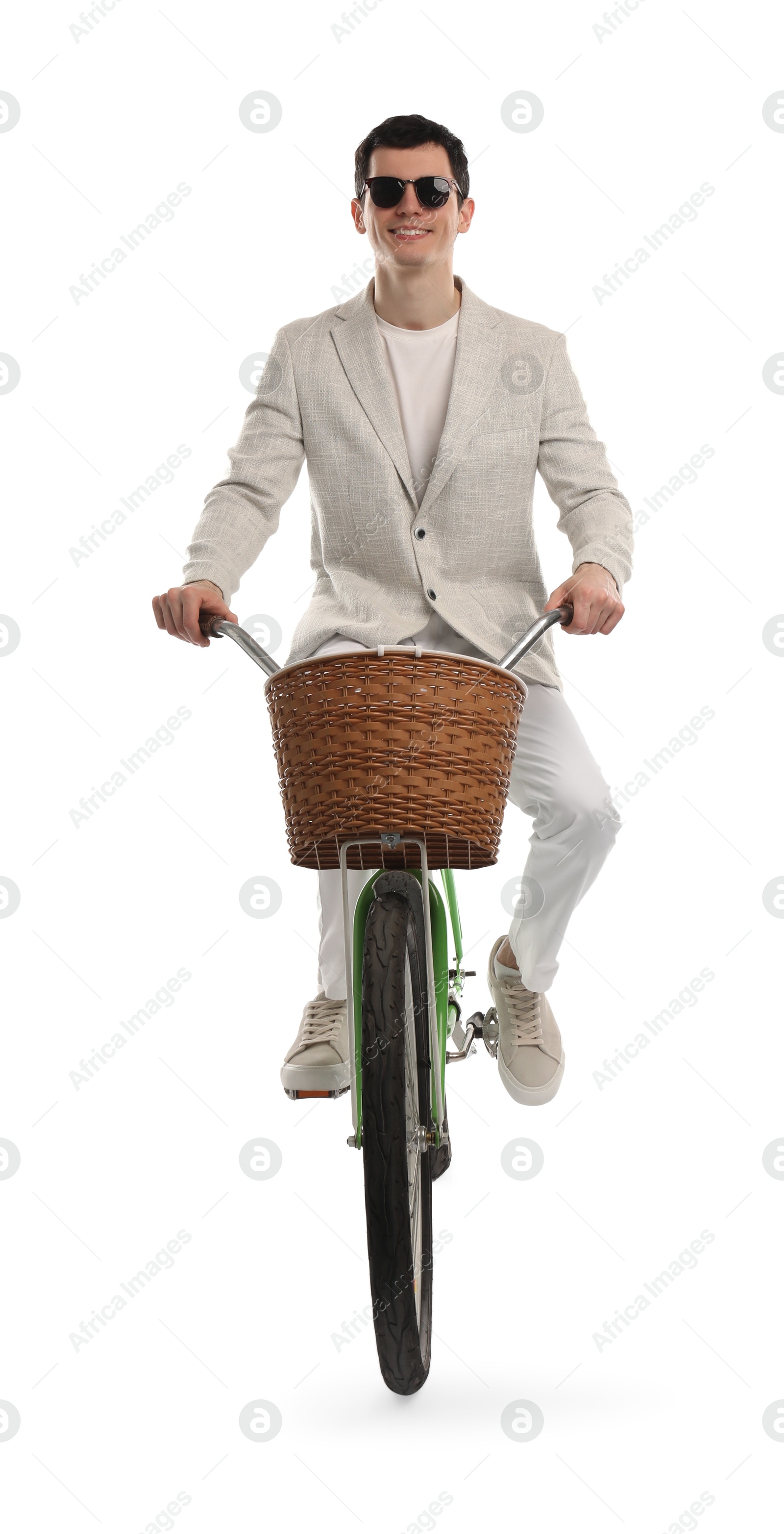 Photo of Smiling man in sunglasses riding bicycle with basket on white background