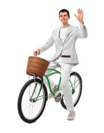 Smiling man on bicycle with basket against white background