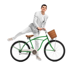 Photo of Smiling man riding bicycle with basket on white background