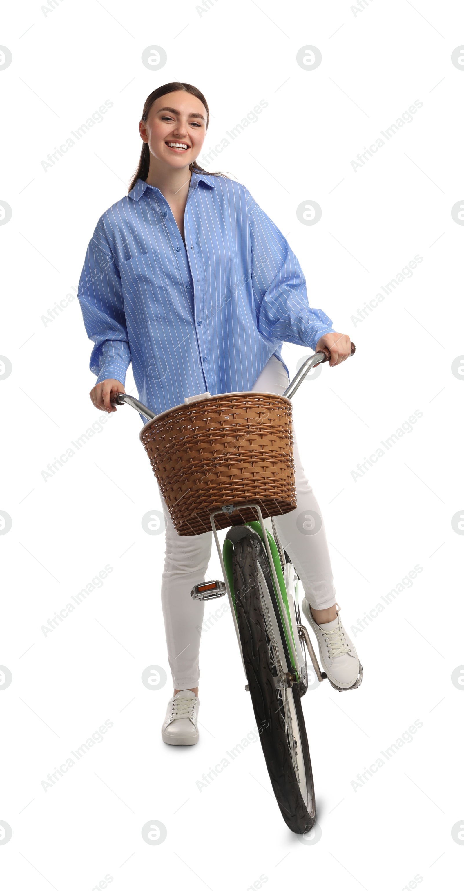 Photo of Smiling woman riding bicycle with basket on white background