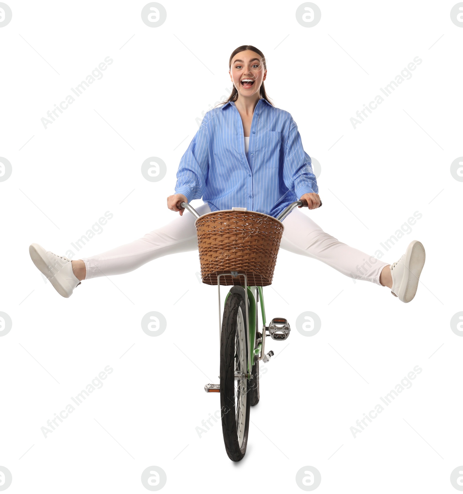 Photo of Emotional woman having fun while riding bicycle with basket against white background