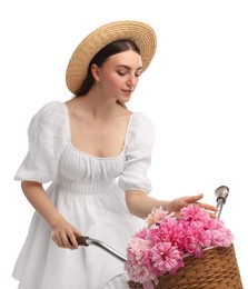 Beautiful young woman with bicycle and basket of peony flowers isolated on white