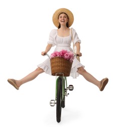 Photo of Emotional woman having fun on bicycle with basket of peony flowers against white background