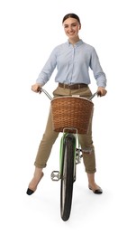 Photo of Smiling woman riding bicycle with basket on white background