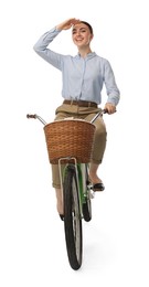 Photo of Smiling woman riding bicycle with basket on white background