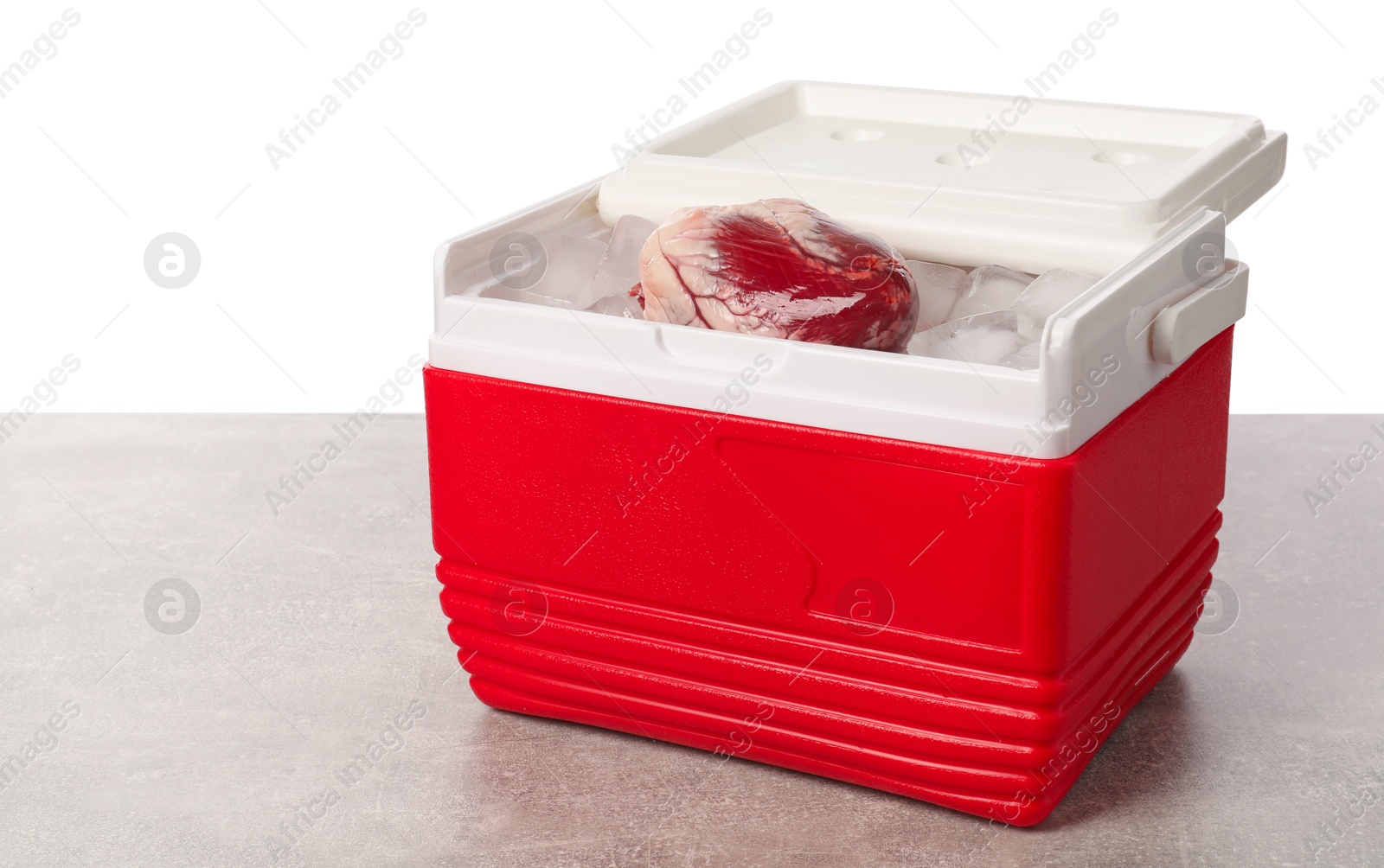 Photo of Heart with ice in cool box on grey table against white background