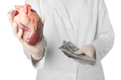 Photo of Doctor with heart and dollar banknotes on white background, closeup