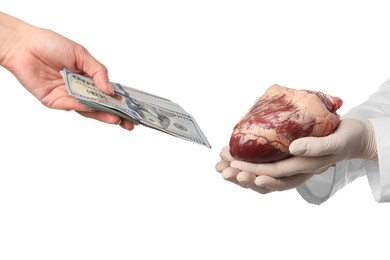 Patient giving dollar banknotes to doctor with heart on white background, closeup