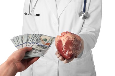 Patient giving dollar banknotes to doctor with heart on white background, closeup